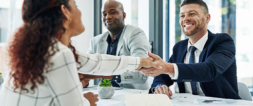 Shot of businesspeople shaking hands in an office
