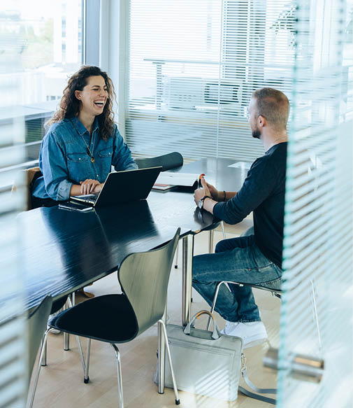 Smiling businesswoman taking interview with a man  Job interview in office boardroom 